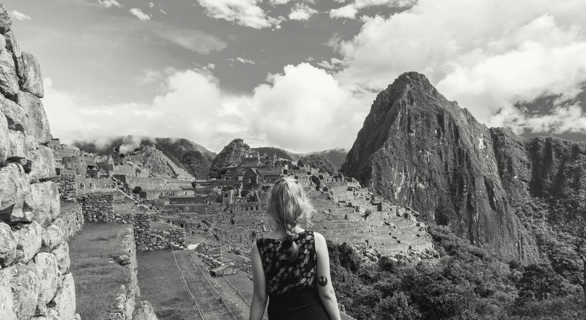 A woman looking out over the terraces at Machu Picchu